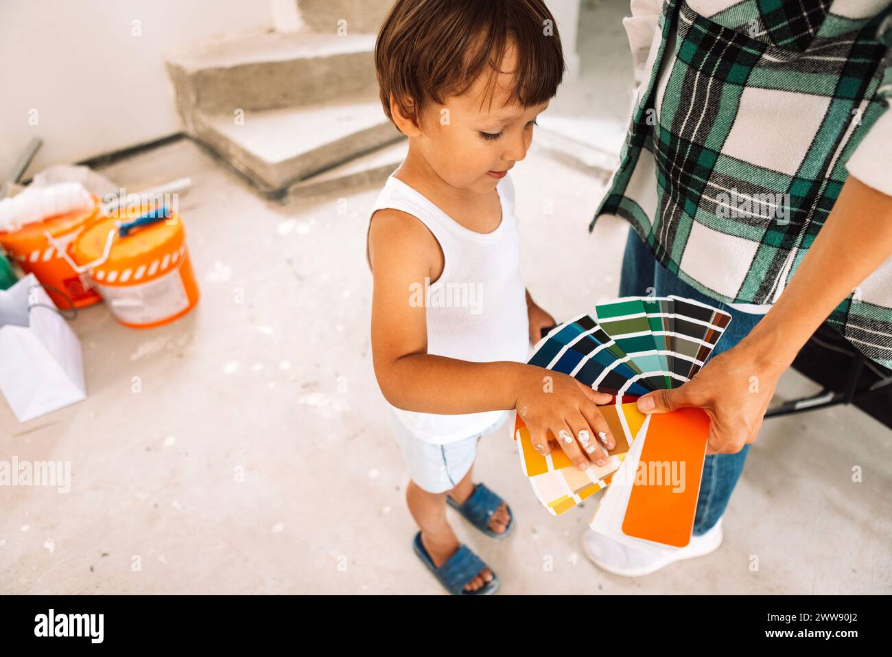 Close-up of a woman hand holding a palette of colors. A cute child ...