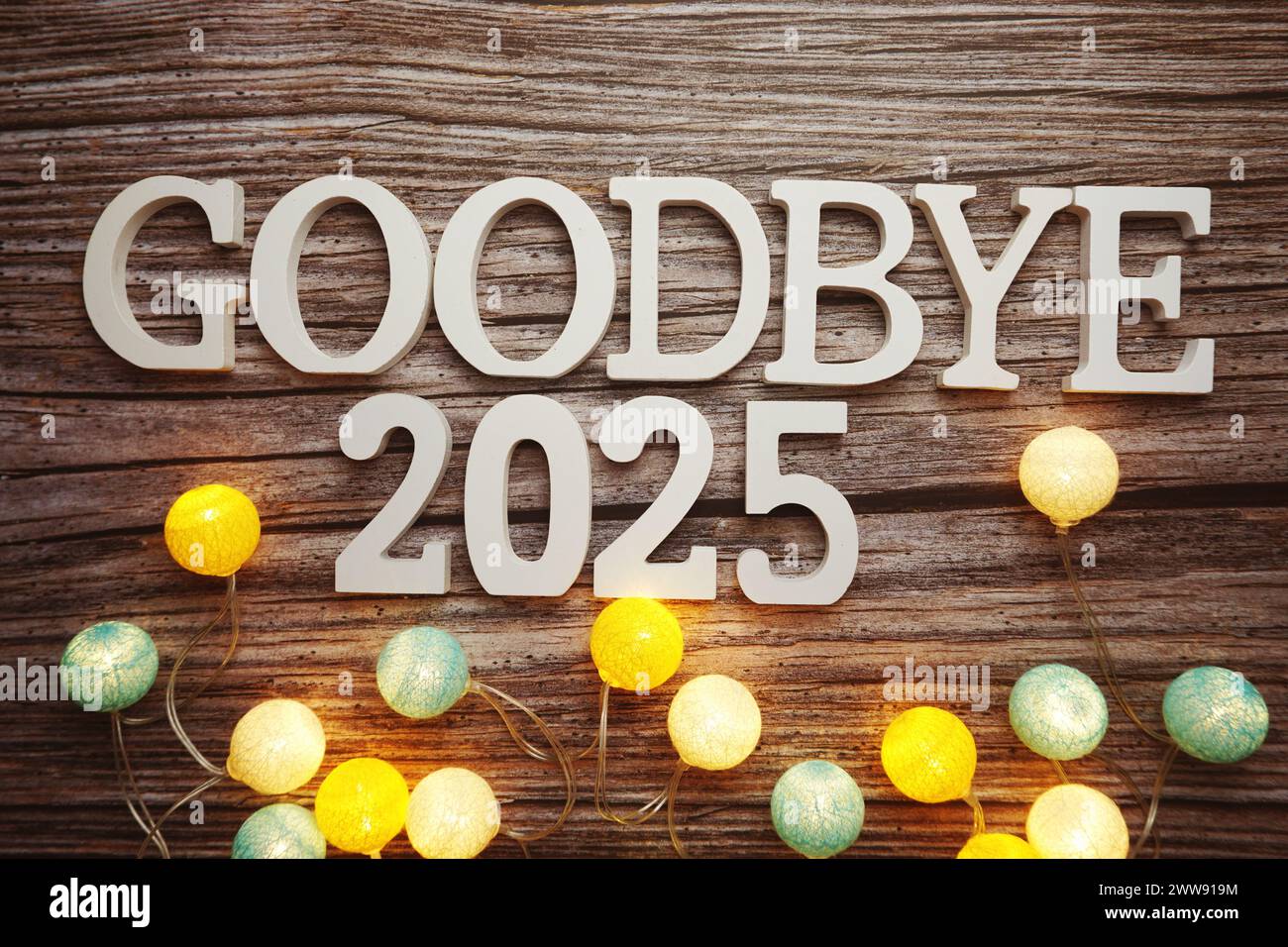 Goodbye 2025 alphabet letter with cotton ball LED decoration on wooden background Stock Photo