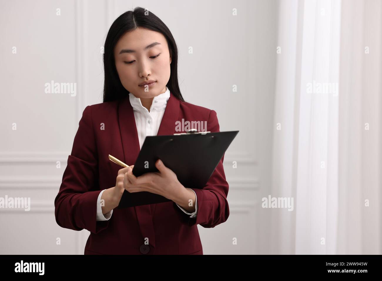 Portrait of notary with clipboard in office. Space for text Stock Photo