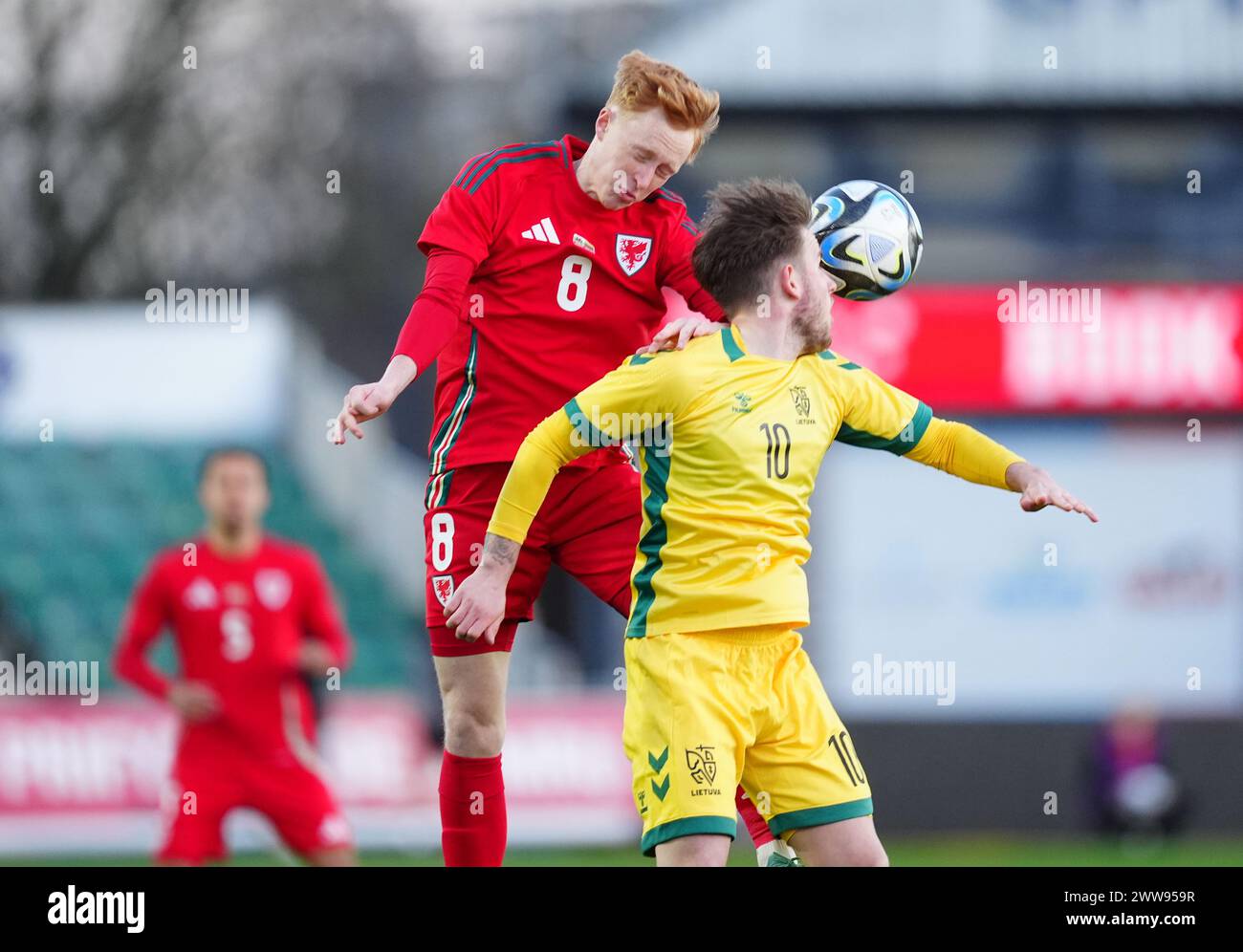 Wales' Oliver Hammond (left) and Lithuania's Titas Buzas battle for the ball during the UEFA Euro U21 Championship Group I match at Rodney Parade, Newport. Picture date: Friday March 22, 2024. Stock Photo