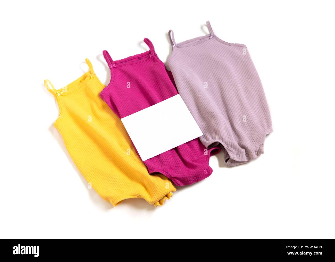 Seconhand, donate concept. Used kids clothes with empty paper blank