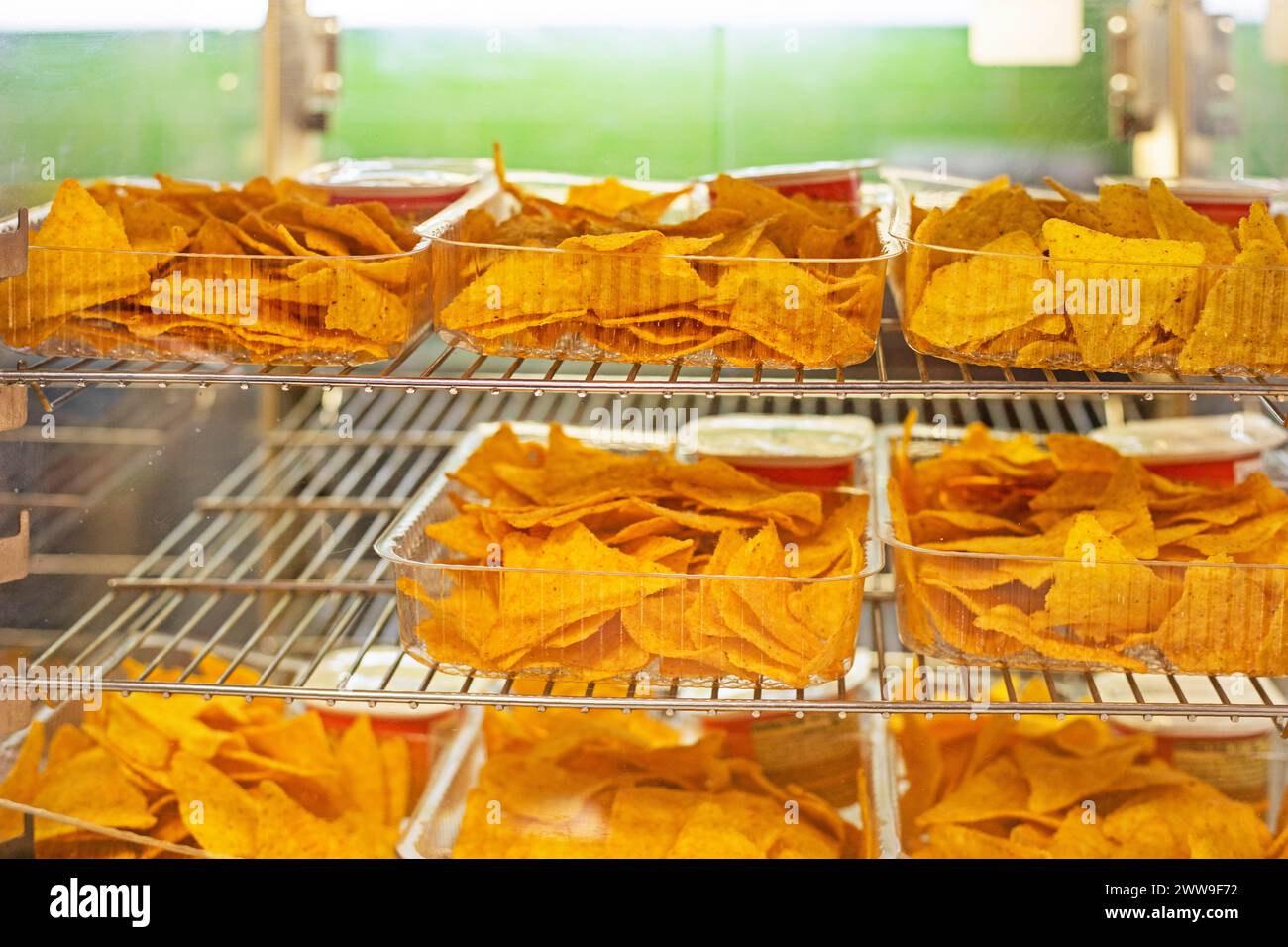 crispy potato chips with different flavors in plastic containers. cinephile Stock Photo