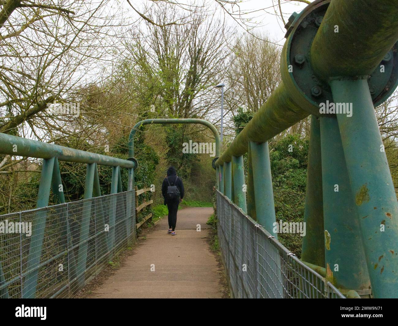 Woman walking on a bridge Stock Photo