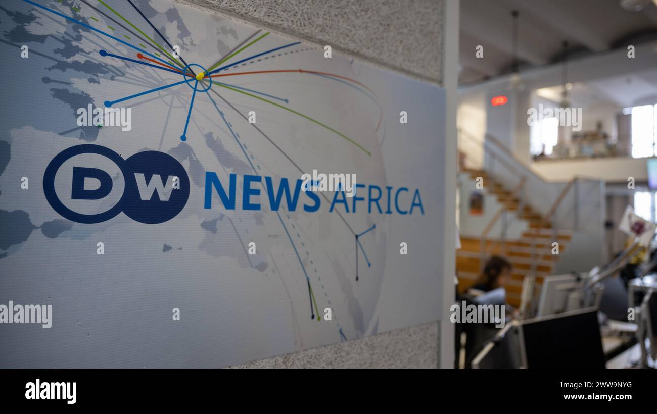 Berlin, Germany. 22nd Mar, 2024. A logo with the inscription DW News Africa hangs in the newsroom at the capital city headquarters of the broadcaster Deutsche Welle. DW is a public-law institution and works in three media: television, radio and internet. Credit: Monika Skolimowska/dpa/Alamy Live News Stock Photo