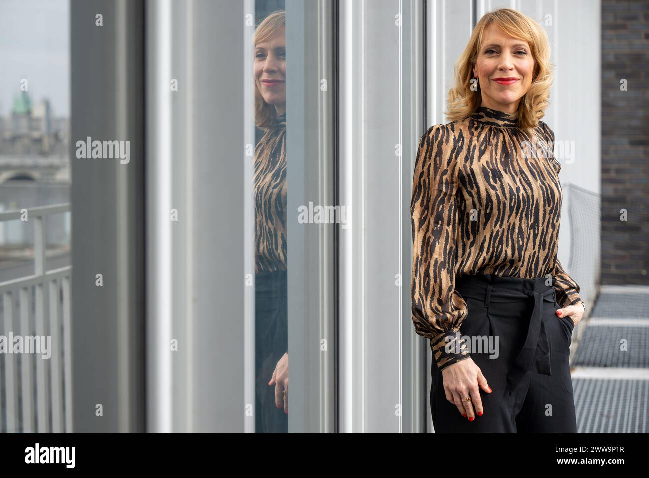Berlin, Germany. 22nd Mar, 2024. Nadja Scholz, Program Director of Deutsche Welle, on the balcony in front of her office at the broadcaster's capital city headquarters. DW is a public-law institution and works across three media: television, radio and the Internet. Credit: Monika Skolimowska/dpa/Alamy Live News Stock Photo