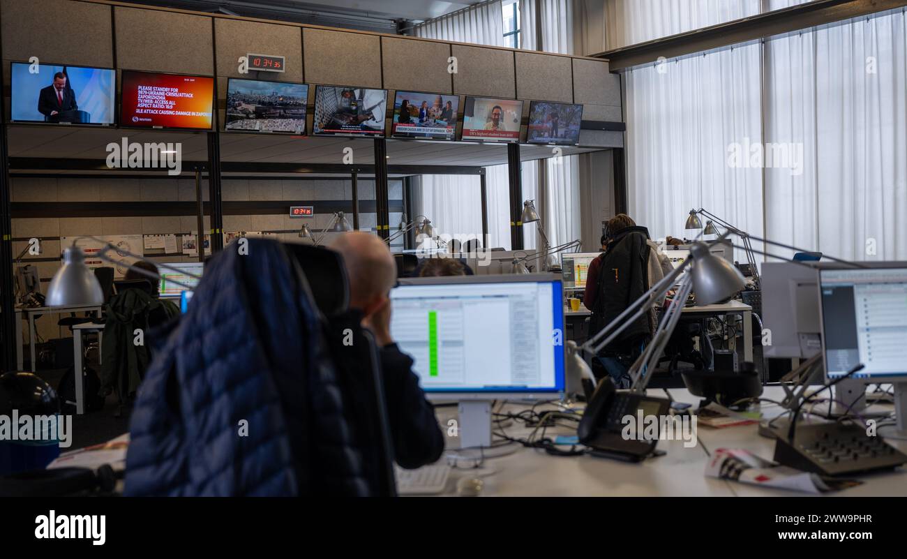 Berlin, Germany. 22nd Mar, 2024. Employees sit in the newsroom at the capital city headquarters of the broadcaster Deutsche Welle. DW is a public-law institution and works across three media: television, radio and the Internet. Credit: Monika Skolimowska/dpa/Alamy Live News Stock Photo