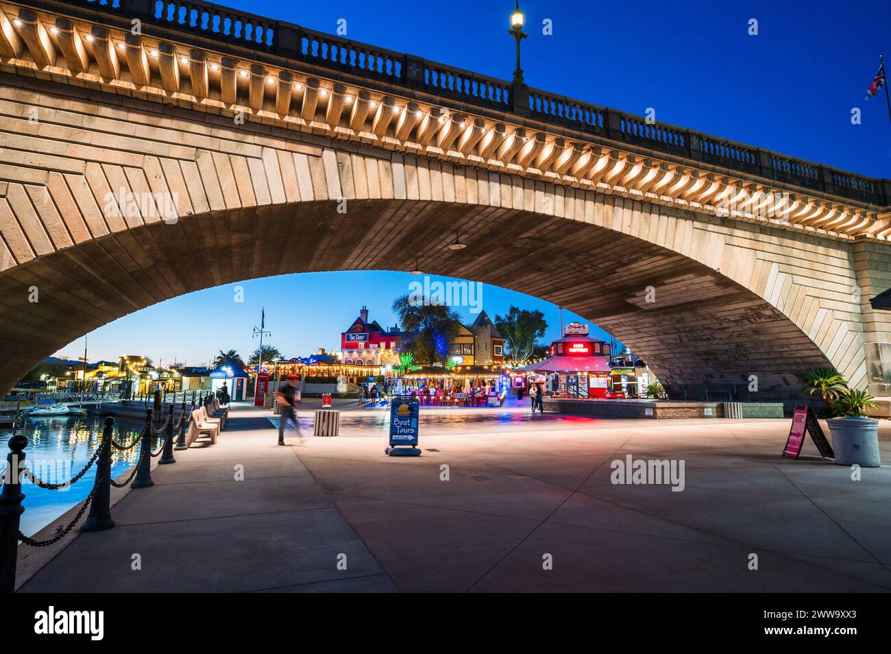 Tourists near the old London Bridge at sunset, which was relocated from London England in the 1970’s to Lake Havasu Arizona. Stock Photo