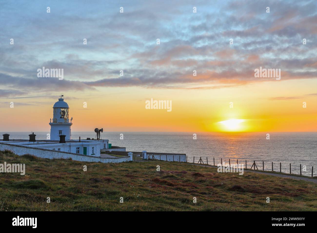 Sunset at the Pendeen Lighthouse, also known as Pendeen Watch, Pendeen, Cornwall, England, UK Stock Photo