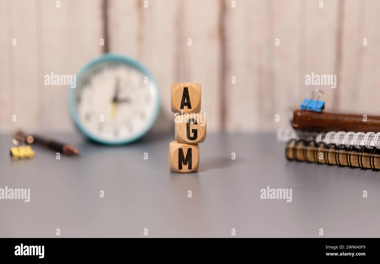 AGM (Annual general meeting) acronym on wooden cubes Stock Photo