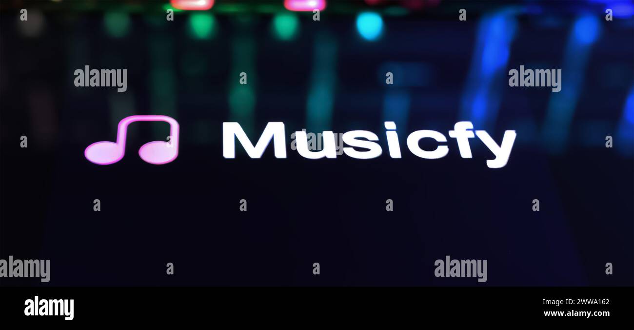 Viersen, Germany - March 9. 2024: Closeup of Smartphone with logo lettering of AI voice song generator Musicfy on computer keyboard Stock Photo