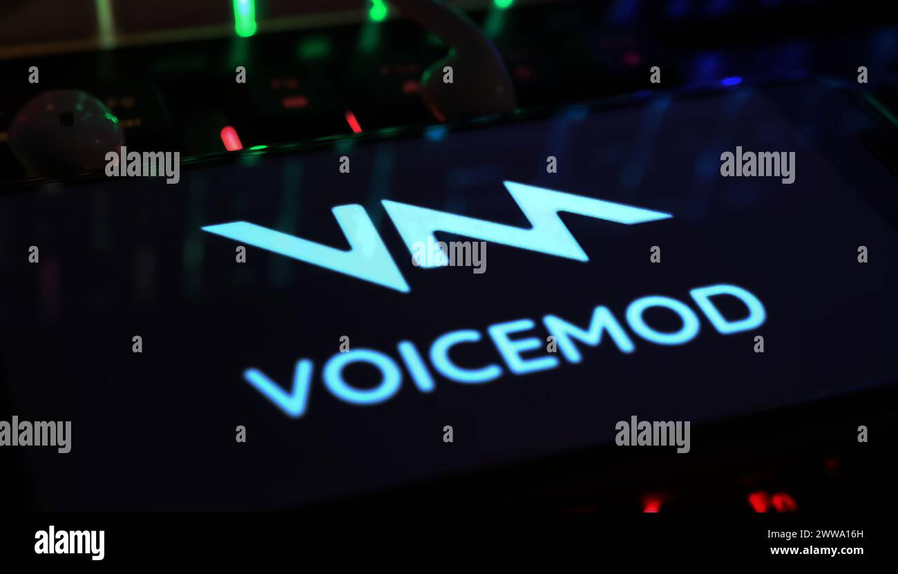 Viersen, Germany - March 9. 2024: Closeup of Smartphone with logo lettering of AI voicemod VM voice changer on computer keyboard Stock Photo
