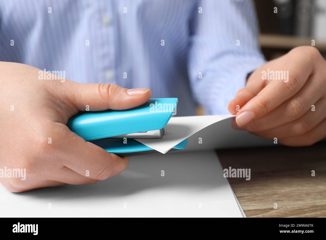 Blue stapler stapling papers hi-res stock photography and images - Alamy