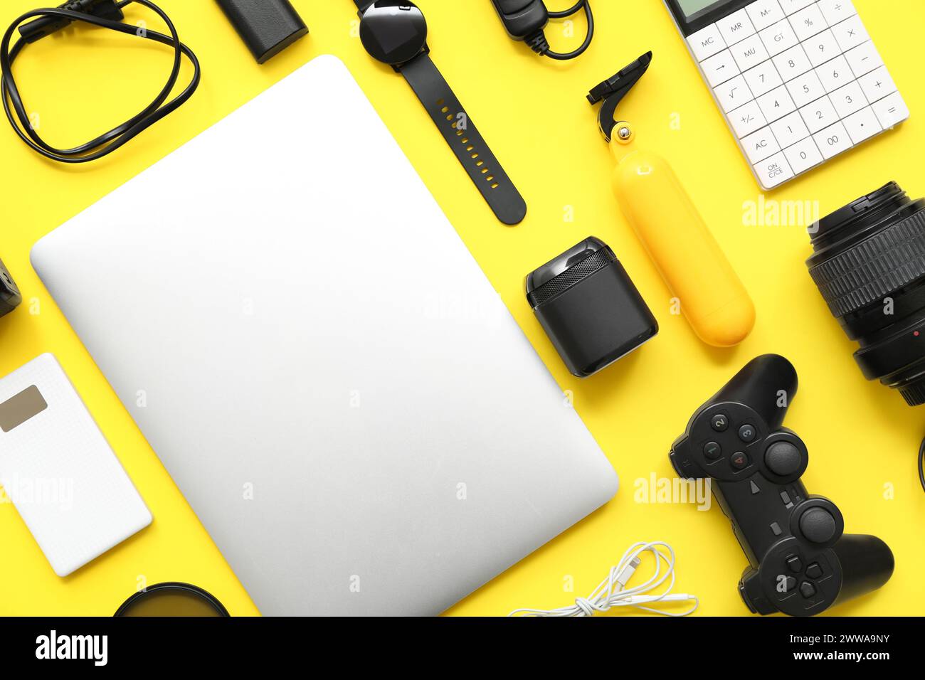Composition with modern gadgets on yellow background Stock Photo
