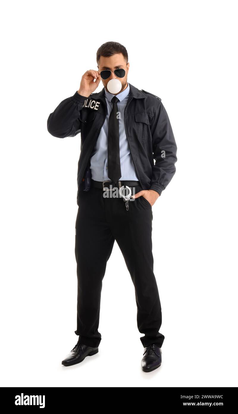 Male police officer blowing bubble gum on white background Stock Photo