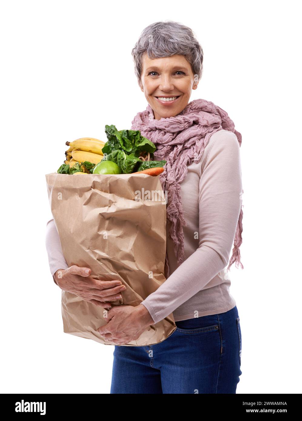 Woman, paper bag and portrait with vegetables for shopping, groceries and consumer for nutrition and fruits in studio. Mature lady, happy and hold Stock Photo