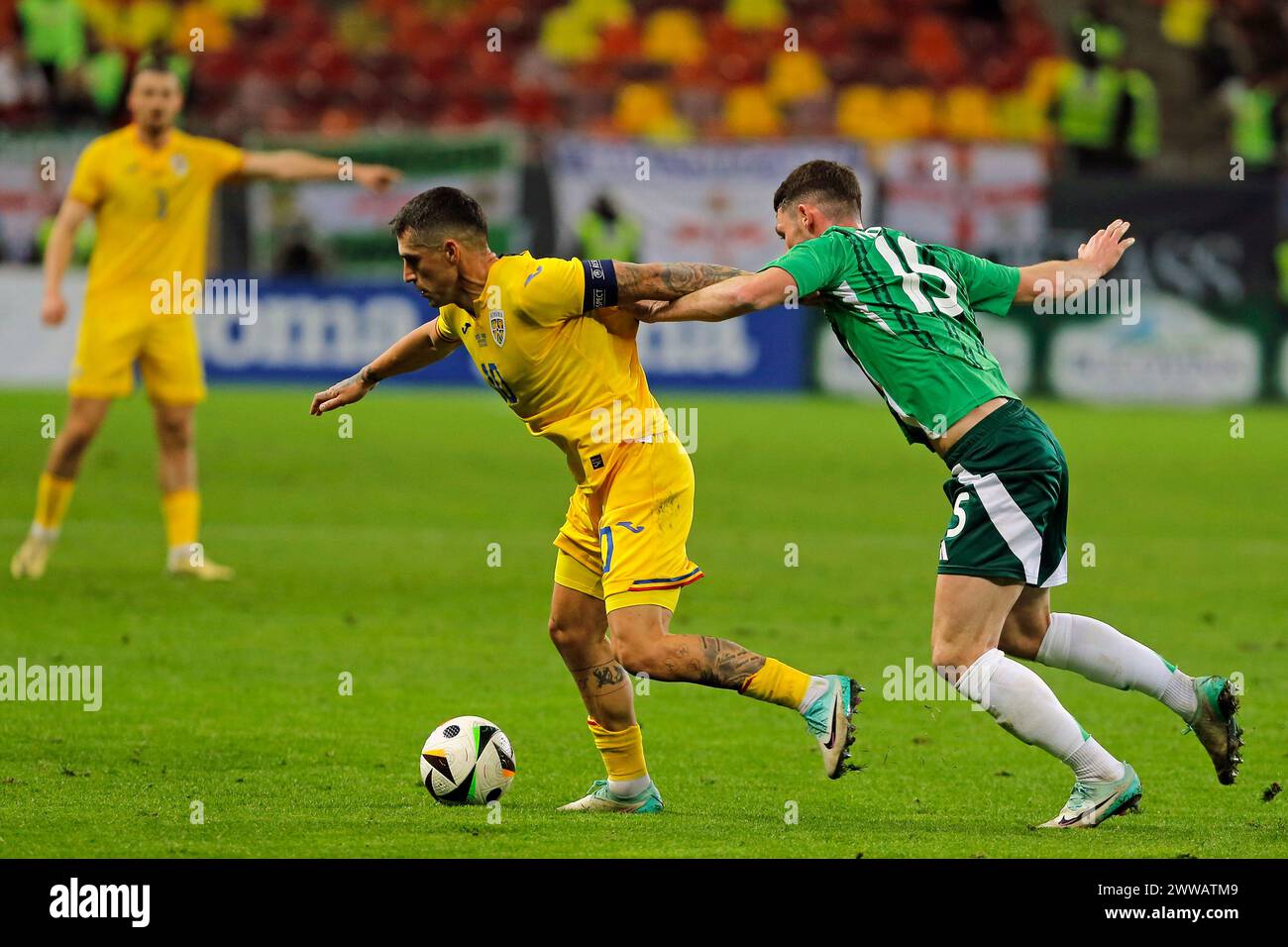 Bucharest, Romania. 22nd Mar, 2024. Nicolae Stanciu (L) of Romania vies with Jordan Thompson of Northern Ireland during the international friendly football match at National Arena in Bucharest, Romania, March 22, 2024. Credit: Cristian Cristel/Xinhua/Alamy Live News Stock Photo