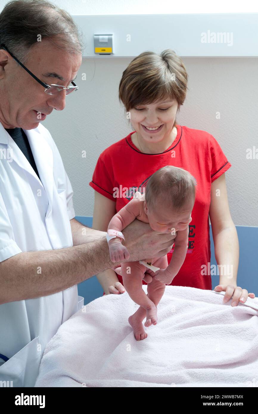 The automatic walking reflex is one of the archaic reflexes noted by the pediatrician during the neurological examination. Stock Photo