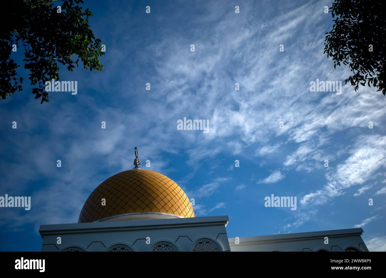 Kubah Masjid. A mosque with a beautiful yellow dome in Yogyakarta, Indonesia with blue sky background. Stock Photo