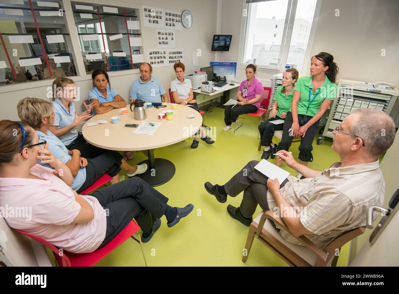 EHPAD - Doctor, nurses and caregivers discussing residents during the time of transmissions. Stock Photo