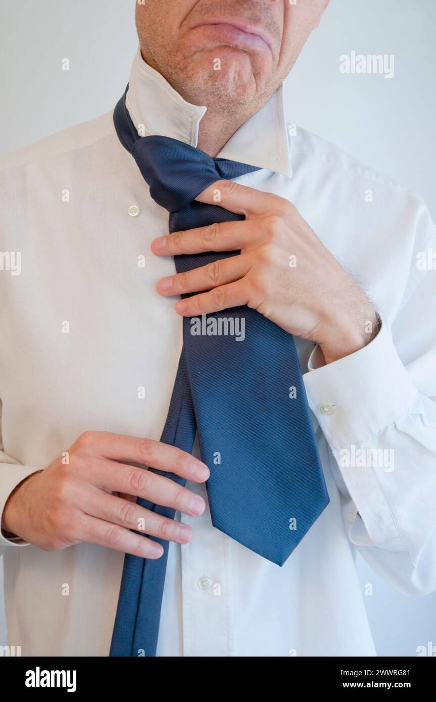 Man tying his necktie. Close view. Stock Photo