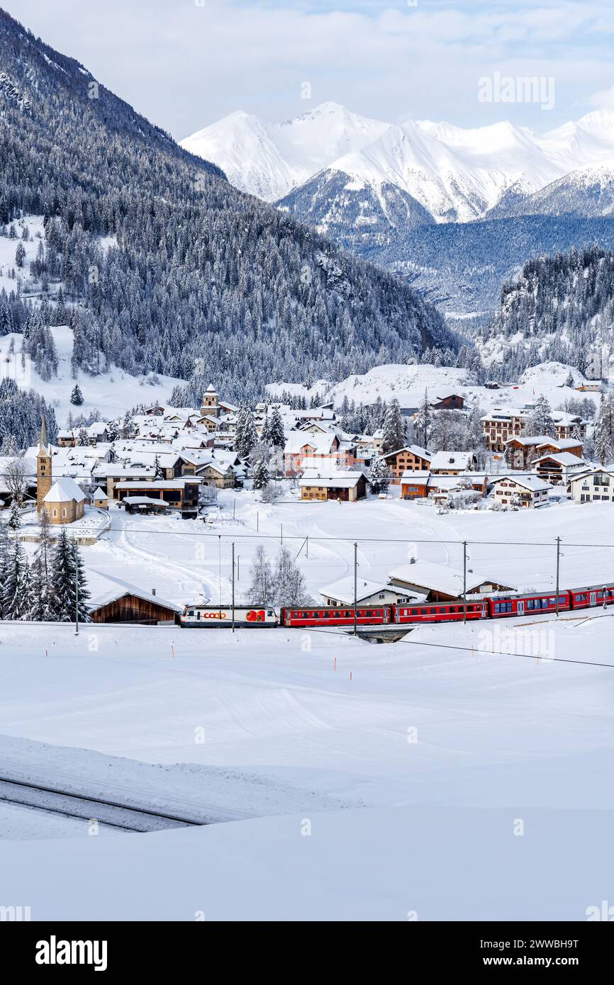 Berguen, Switzerland - January 10, 2024: Rhaetian Railway passenger train on Albula line in the Swiss Alps in Berguen, Switzerland. Stock Photo