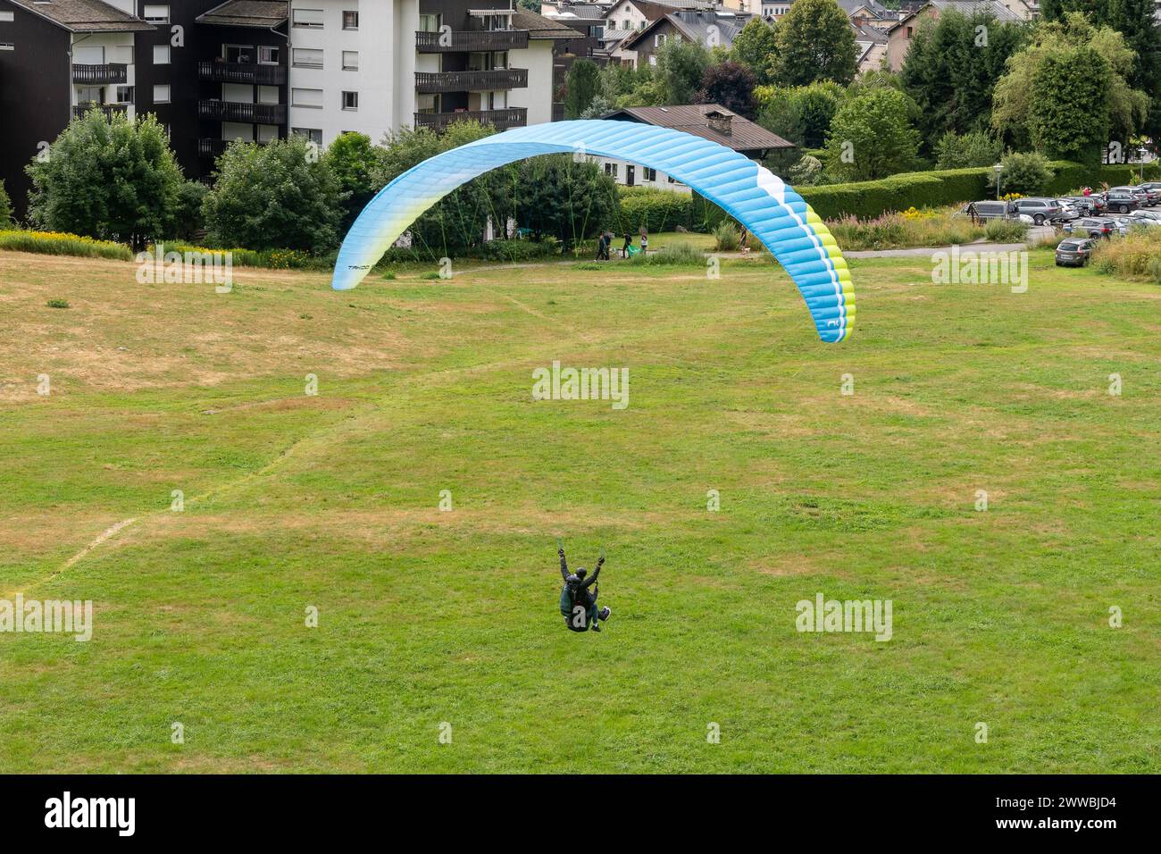 Elevated view of a tandem paragliding arriving at the Savoy landing