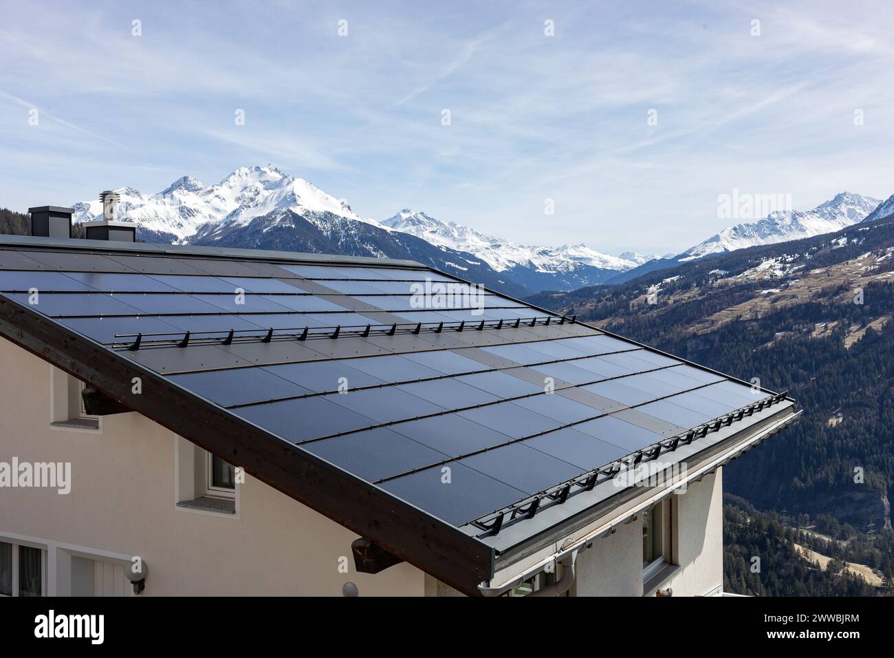 House roof with solar panels in the Swiss Alps Stock Photo