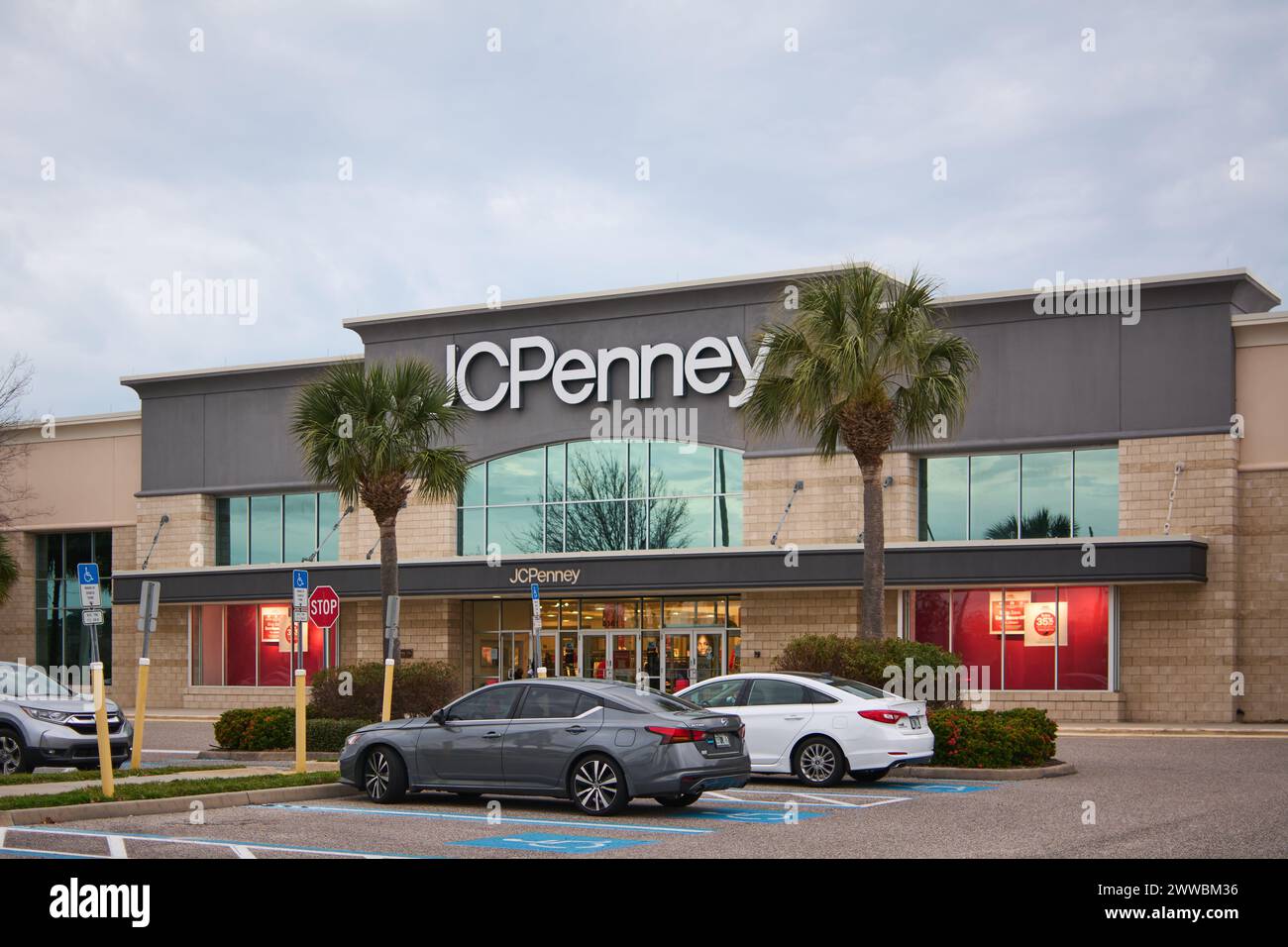 Florida, USA - March 23, 2024: JCPenney store on a cloudy day. You can see cars parked and people walking near the store. The store is surrounded by g Stock Photo