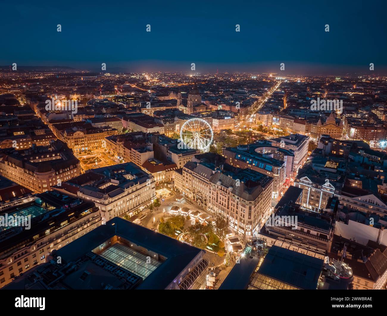 Aerial night cityscape about budapest downtown. Included the Ferris wheel, Erzsebet square, Deak square, Worosmarty square. View of illuminated street Stock Photo