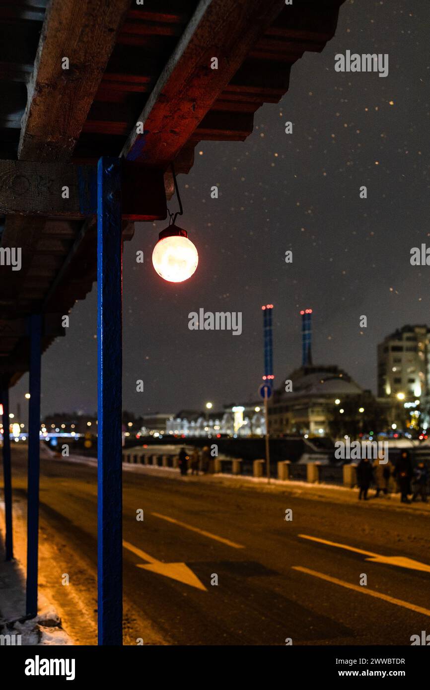 electric lamp of pedestrian crossing being repaired on Kadashevskaya embankment in Moscow city on winter night Stock Photo