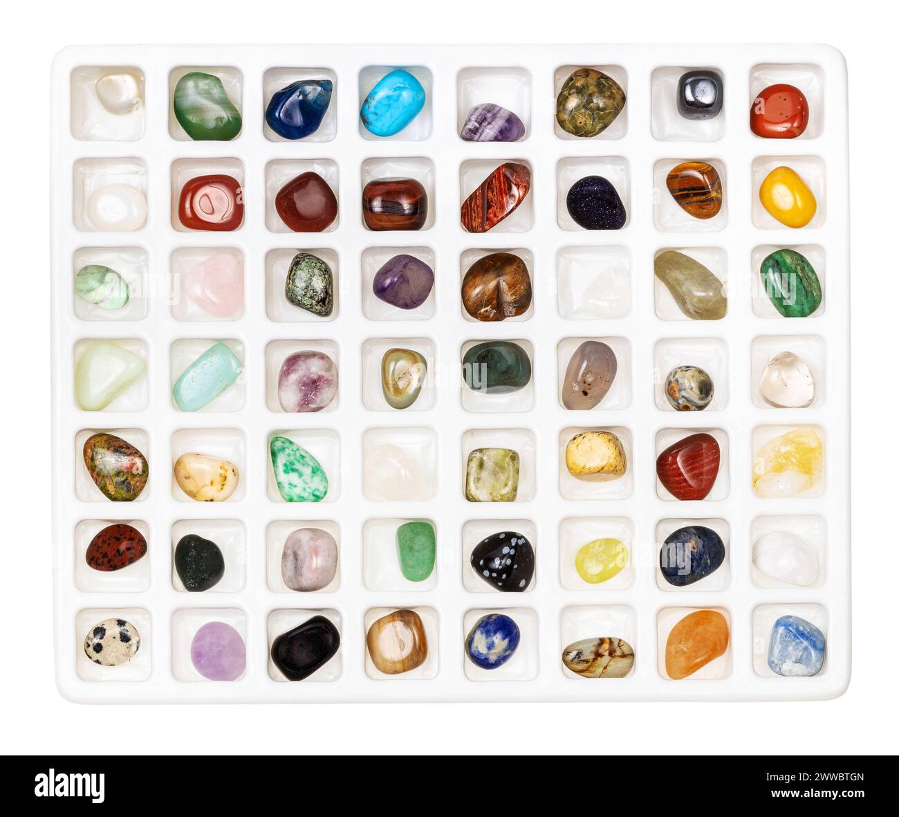 top view on various gemstones for geological collection in open plastic box with cells isolated on white background Stock Photo
