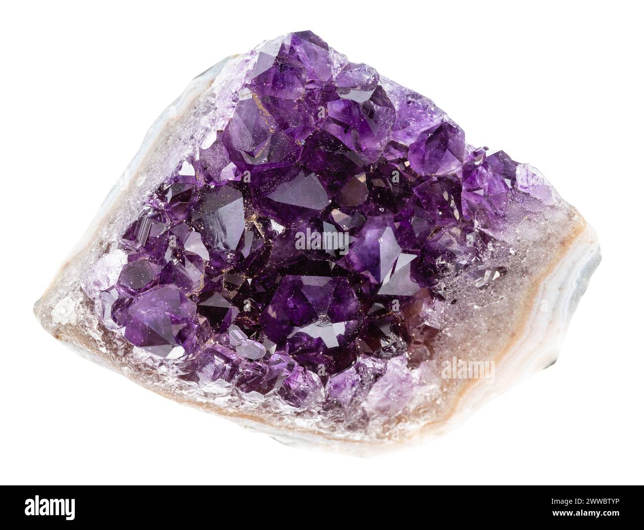 close up of sample of natural stone from geological collection - rough geode of amethyst crystals isolated on white background Stock Photo