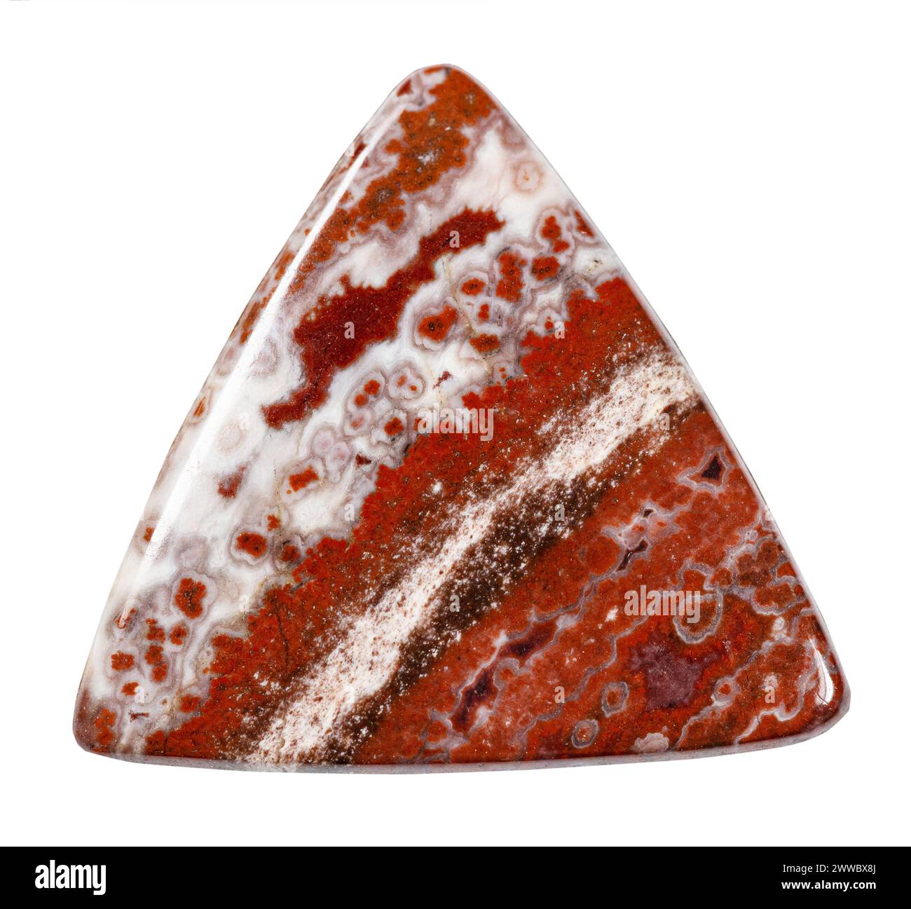 close up of sample of natural stone from geological collection - triangular cabochon from breccia jasper mineral isolated on white background Stock Photo