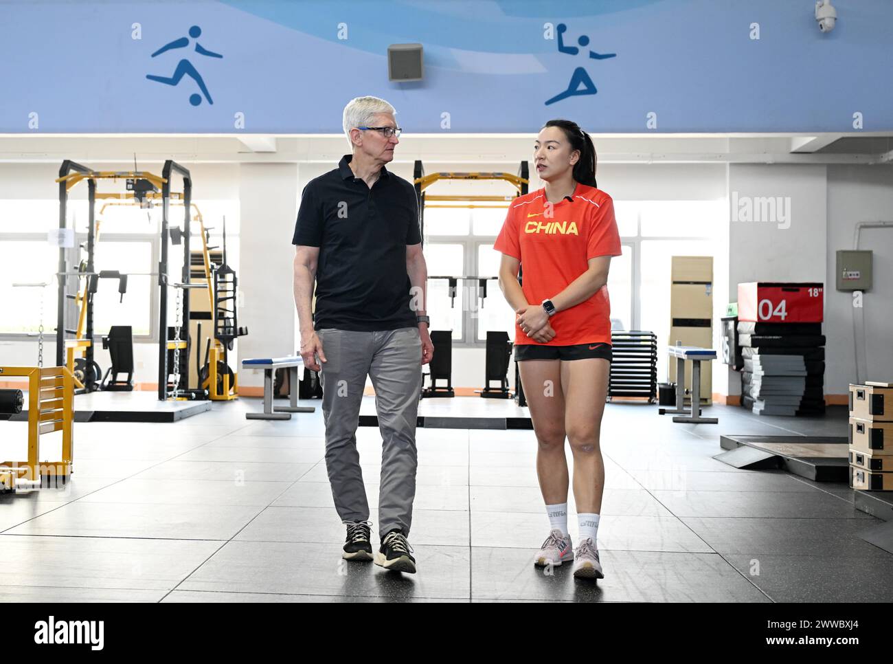 Beijing, China. 23rd Mar, 2024. Apple CEO Tim Cook (L) chats with Chinese women's rugby player Chen Keyi in Beijing, China, March 23, 2024. Apple CEO Tim Cook visited Chinese women's rugby team on Saturday. Credit: Chen Yehua/Xinhua/Alamy Live News Stock Photo