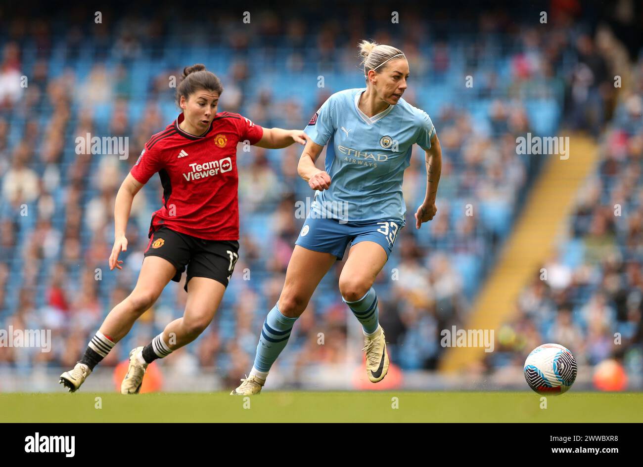 Manchester United's Lucia Garcia (left) and Manchester City's Alanna Kennedy in action during the Barclays Women's Super League match at Etihad Stadium, Manchester. Picture date: Saturday March 23, 2024. Stock Photo