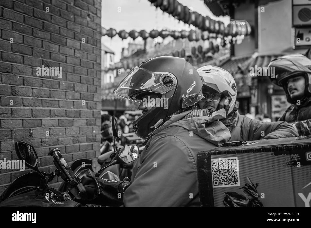 Delivery riders take a break in London's Chinatown. Stock Photo
