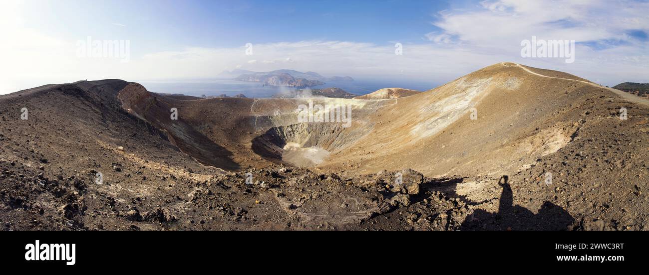 Aeolian Islands, Vulcano, Panoramic view from volcano, Gran Cratere, shadow of hiker at volcanic crater Stock Photo