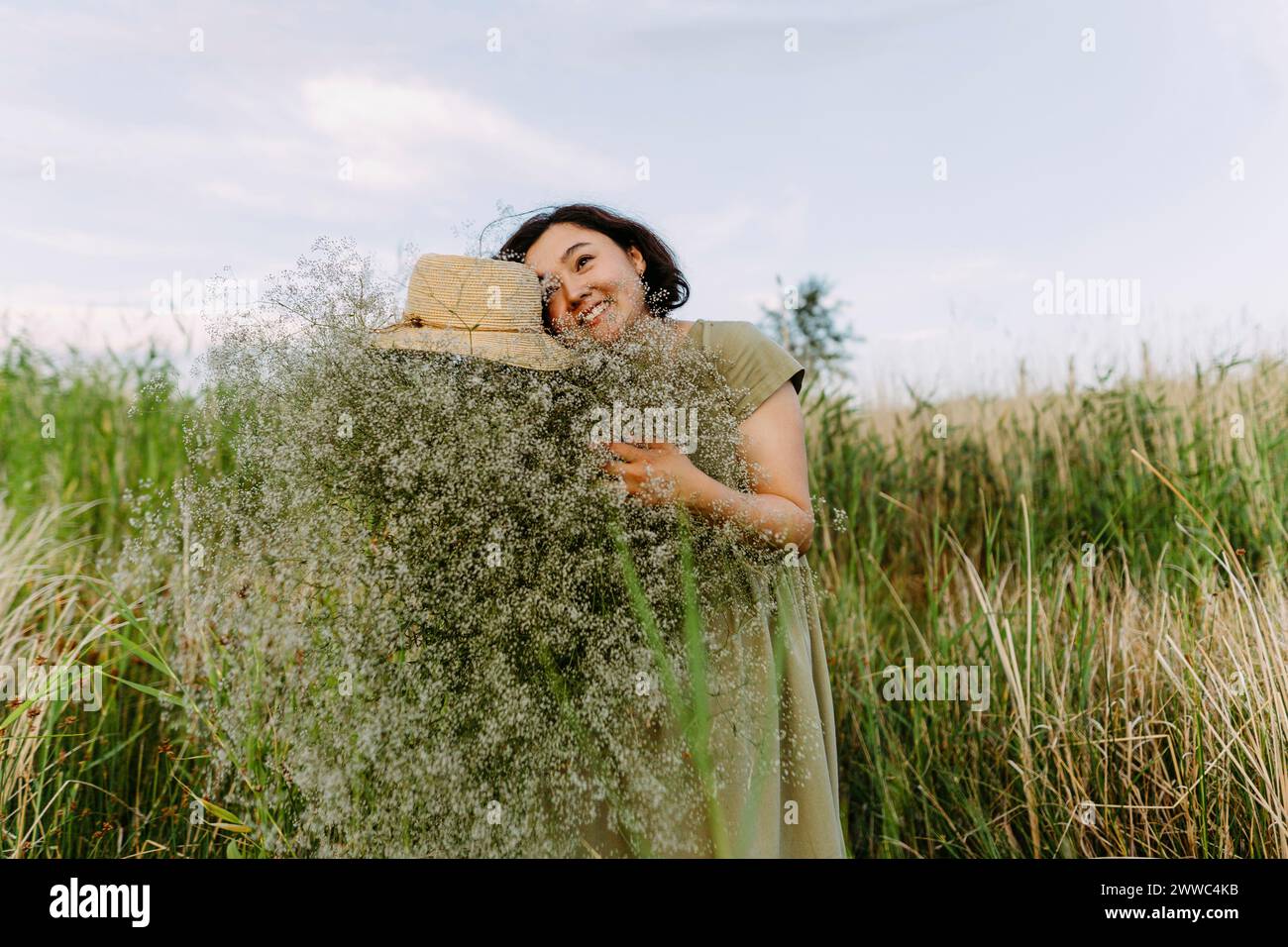 Mature woman flowers field arms hi-res stock photography and images - Alamy