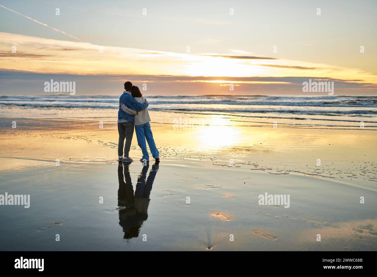 Young woman and man hugging and enjoying sea view at beach Stock Photo ...