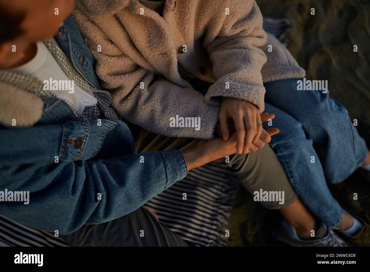 Young man and woman holding hands Stock Photo