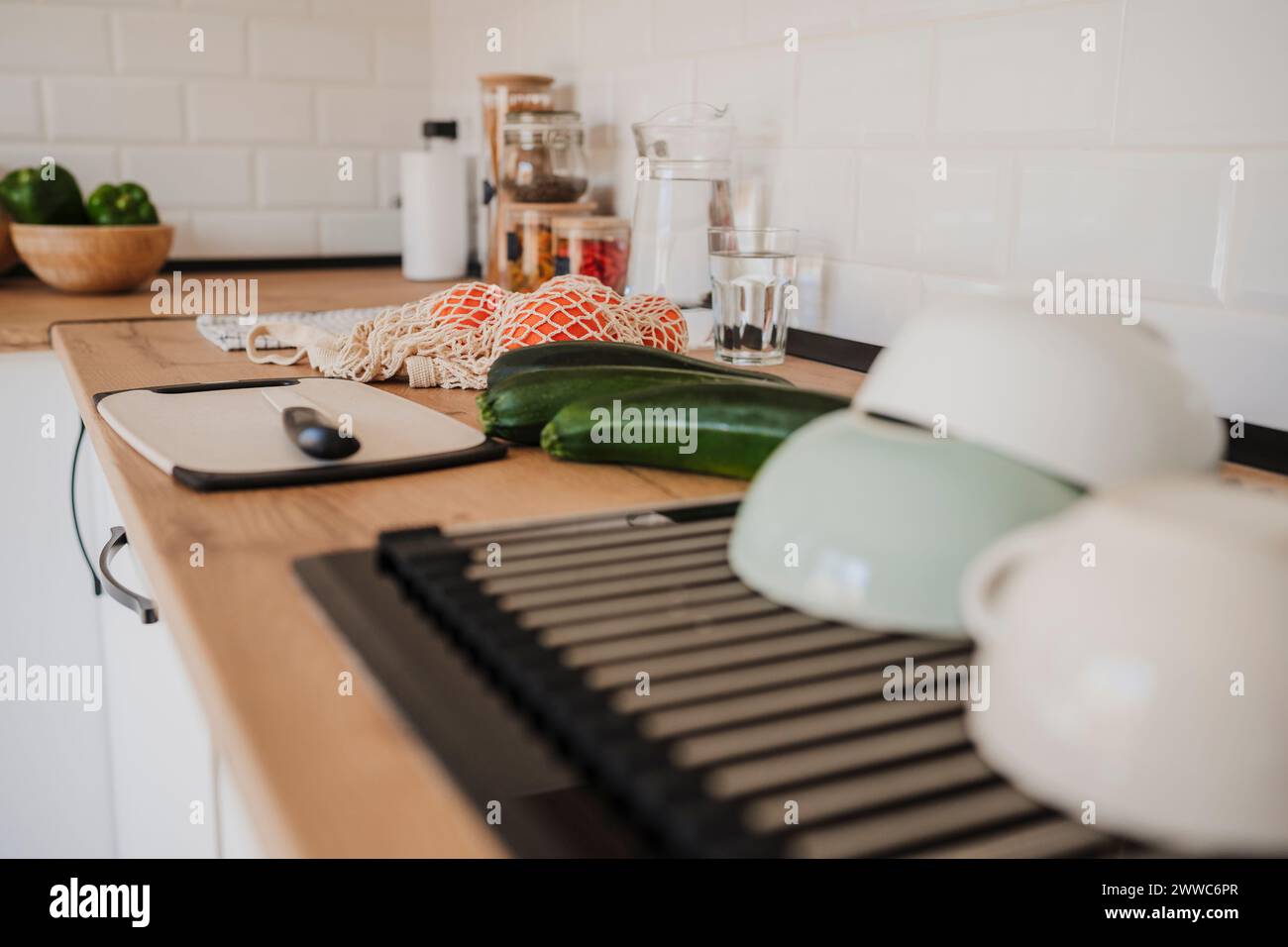 Modern kitchen counter with various food near cutting board and utensils Stock Photo