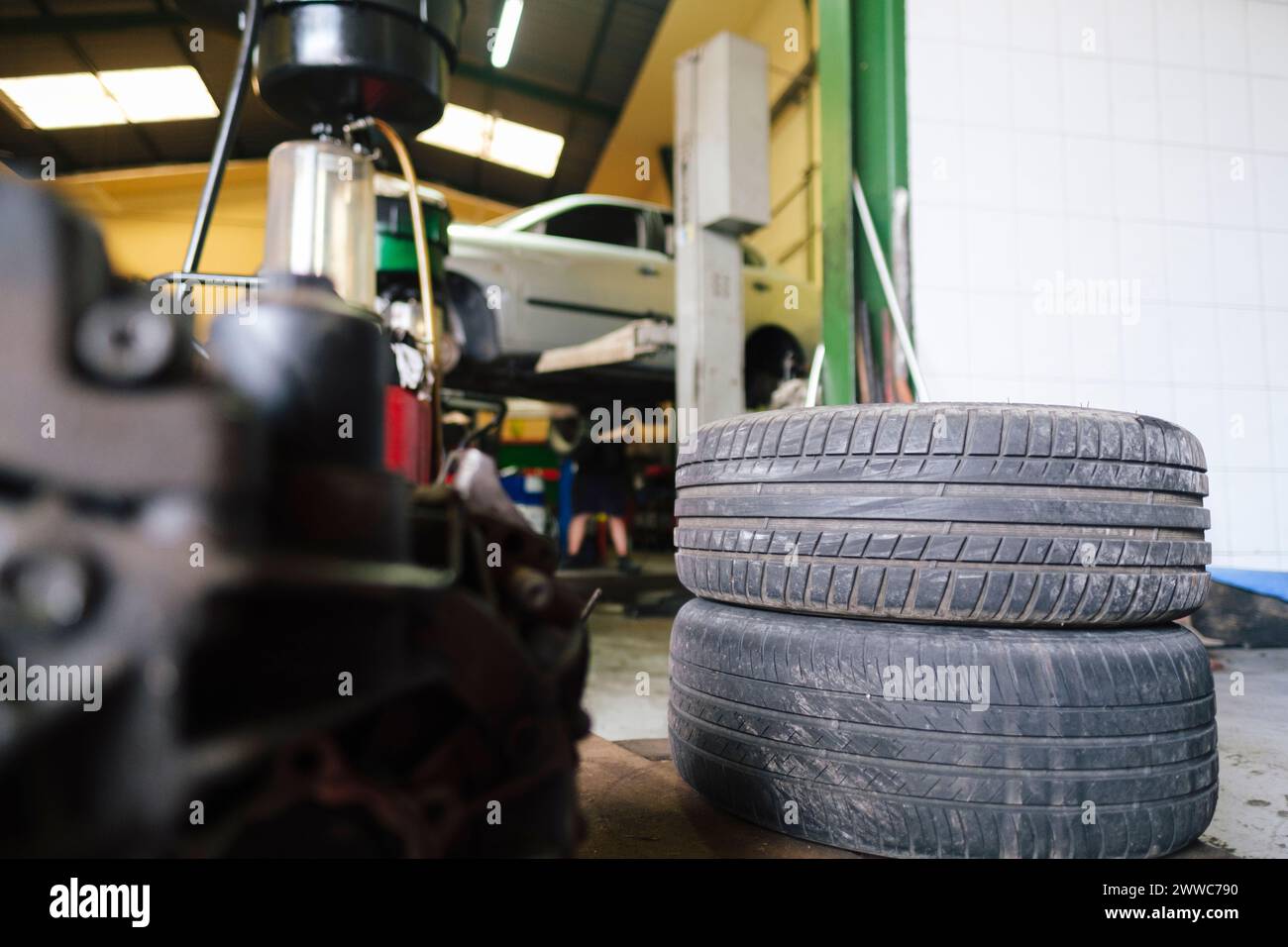 Vehicle tires kept on floor at workshop Stock Photo