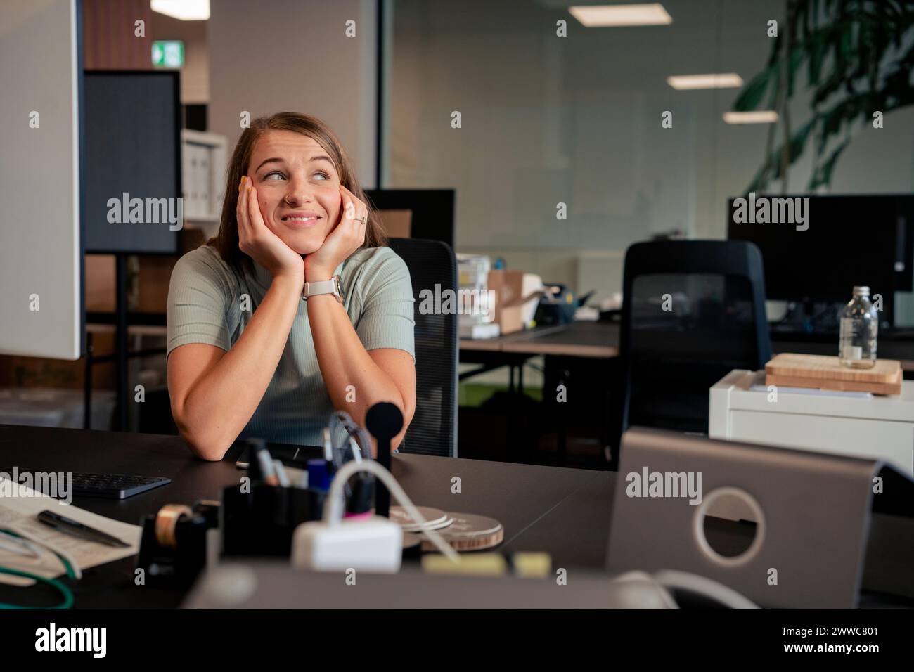 Woman leaning on elbows desk hi-res stock photography and images - Alamy