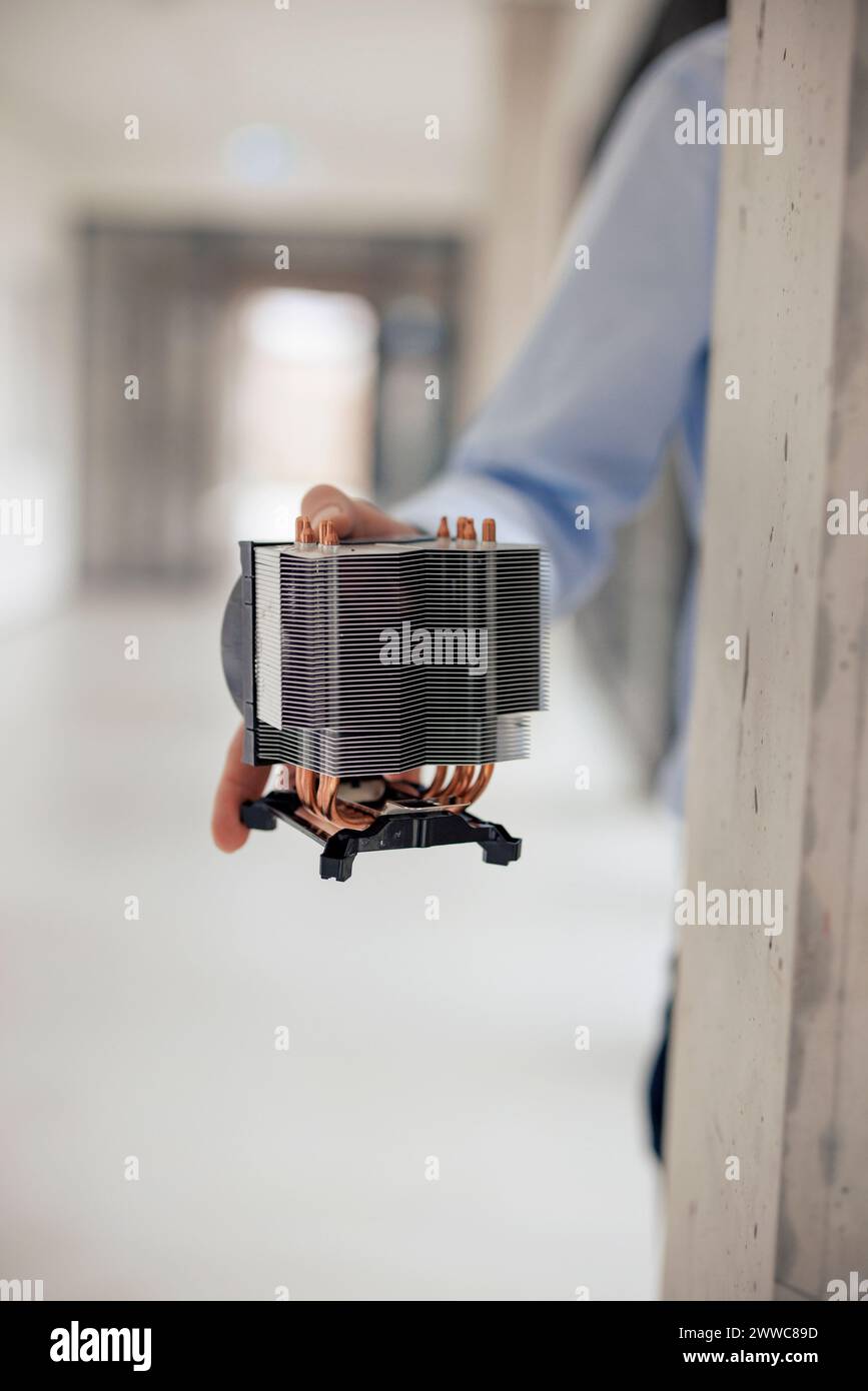 Hand of engineer holding machine part at workshop Stock Photo