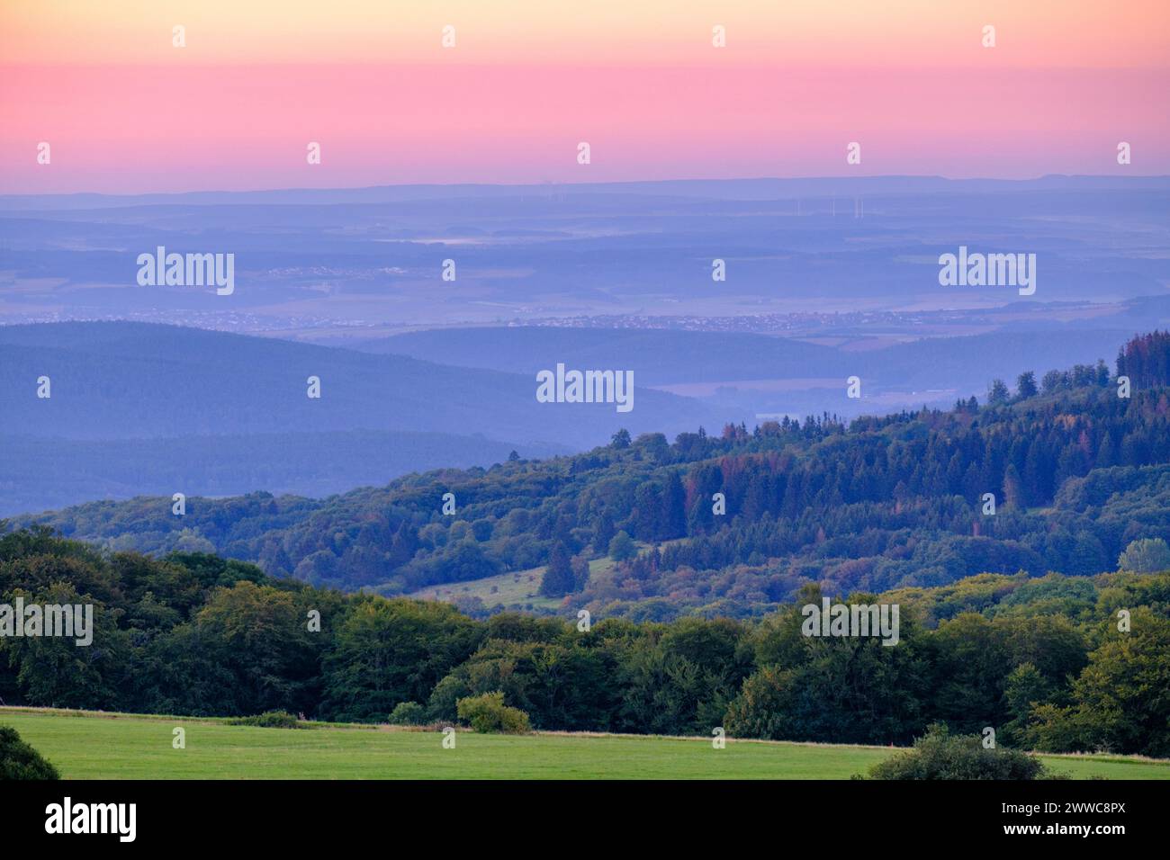 Germany, Bavaria, Forested hills along High Rhon Road at dawn Stock Photo