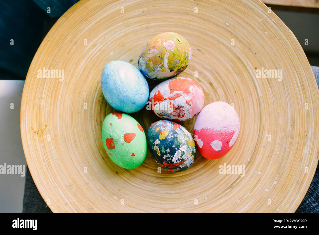 Multi colored Easter eggs in plate at home Stock Photo