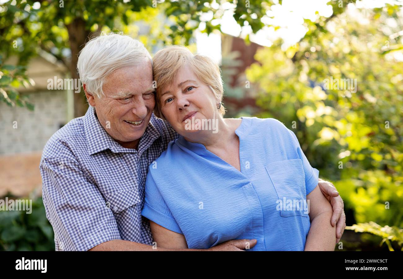 Happy elderly couple spending leisure time in garden Stock Photo - Alamy