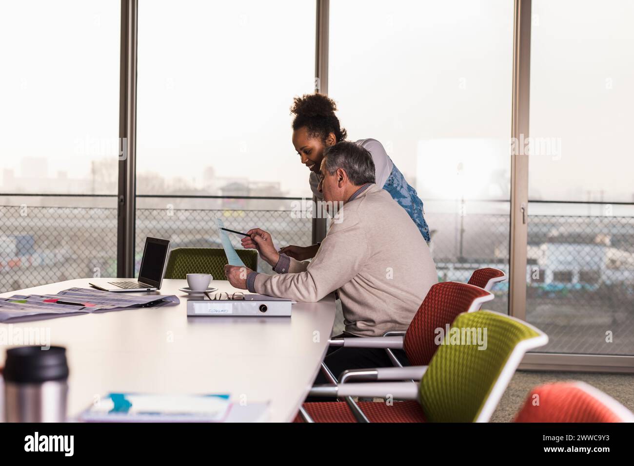 Business colleagues discussing over document in office Stock Photo