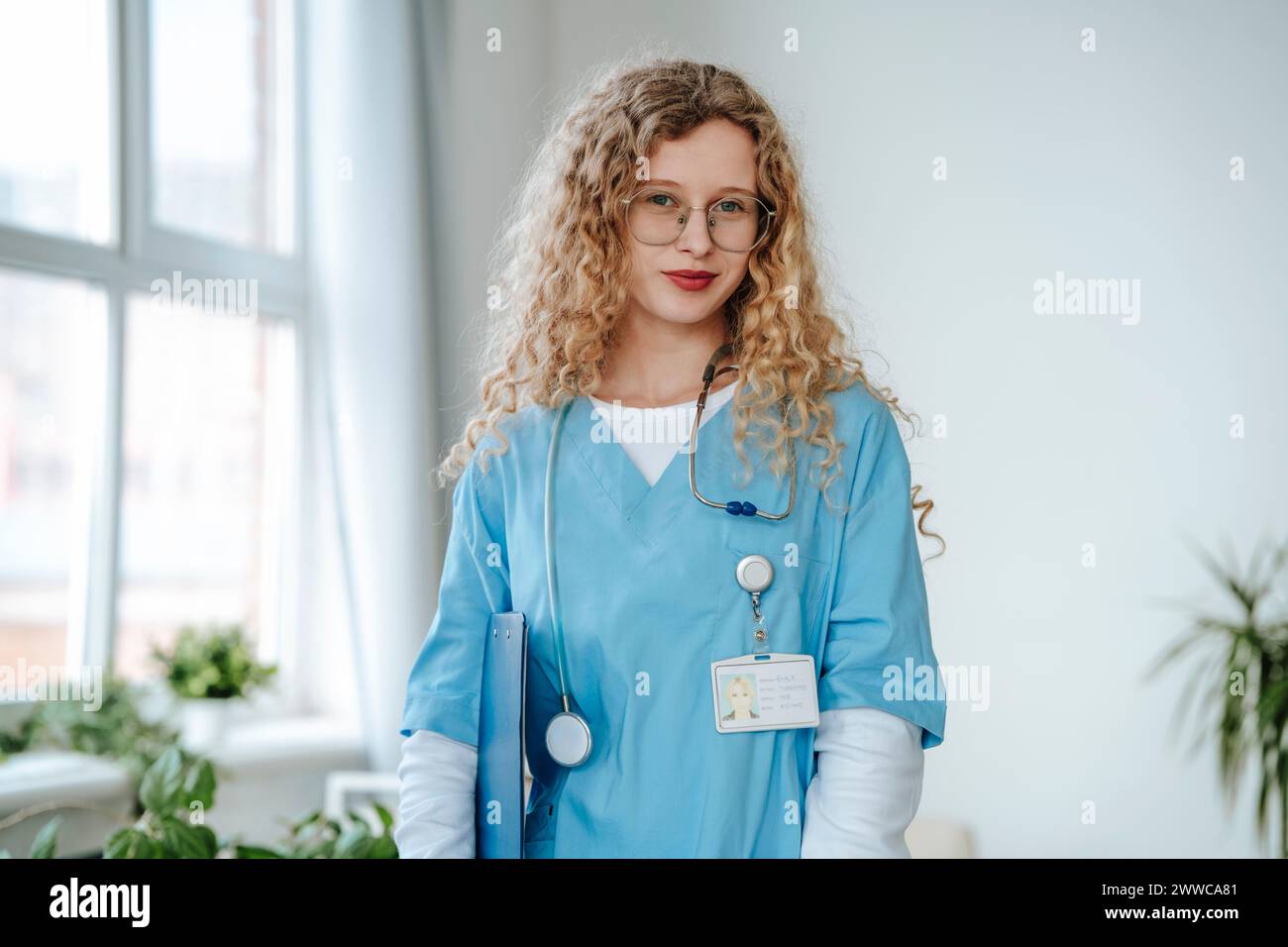 Doctor wearing scrubs and standing in clinic Stock Photo - Alamy