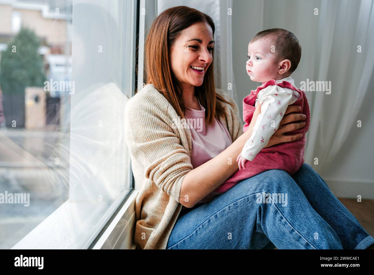 Happy baby girl sits hi-res stock photography and images - Alamy